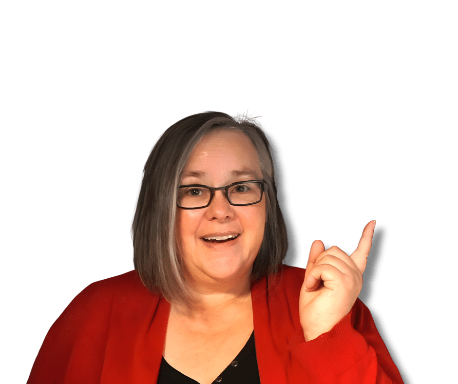 Eine Frau mit Brille und schulterlangem grauem Haar, die eine rote Strickjacke trägt, lächelt und zeigt mit dem rechten Zeigefinger nach oben.